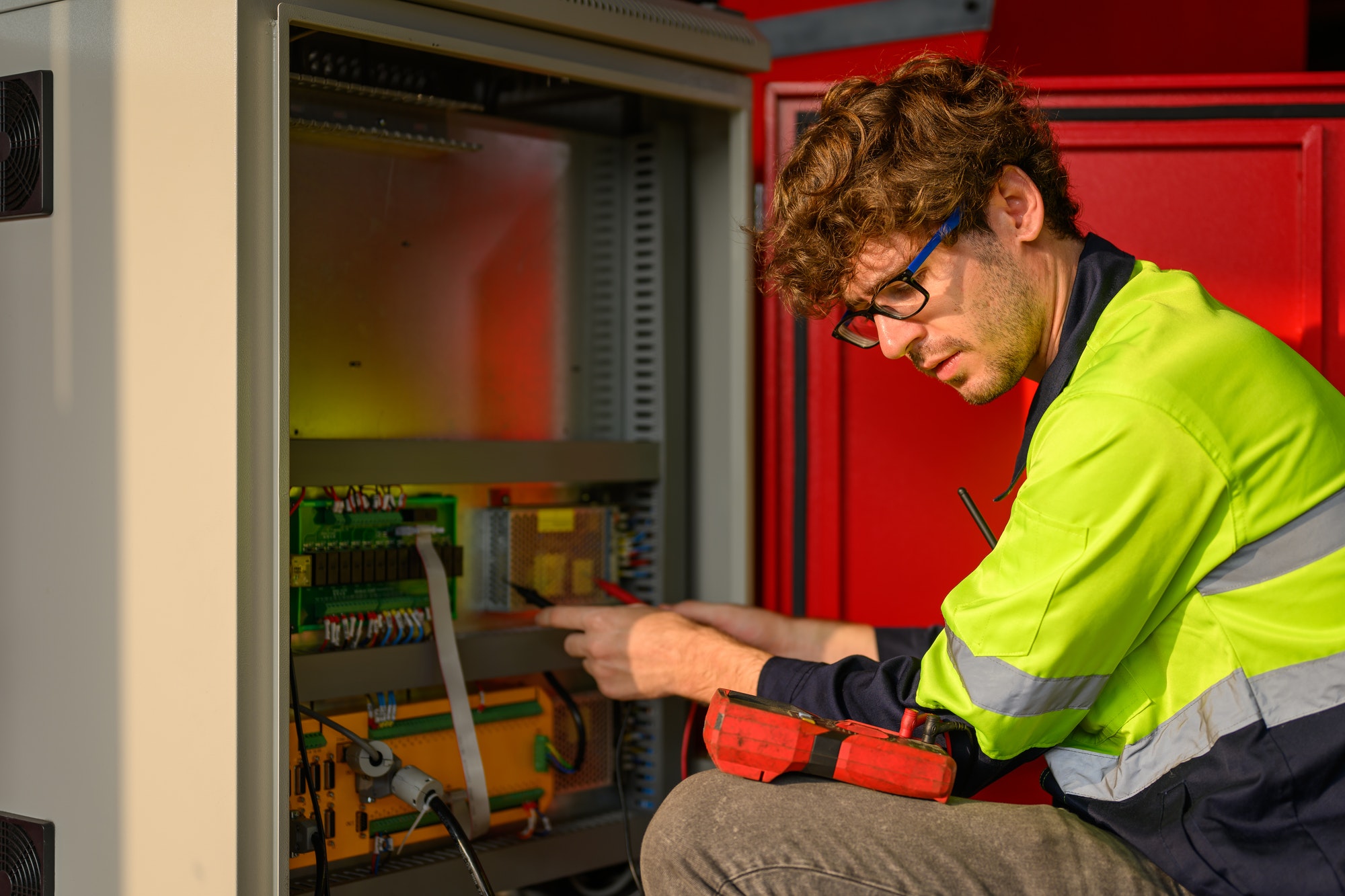 Young technician engineer checking and repairing machine